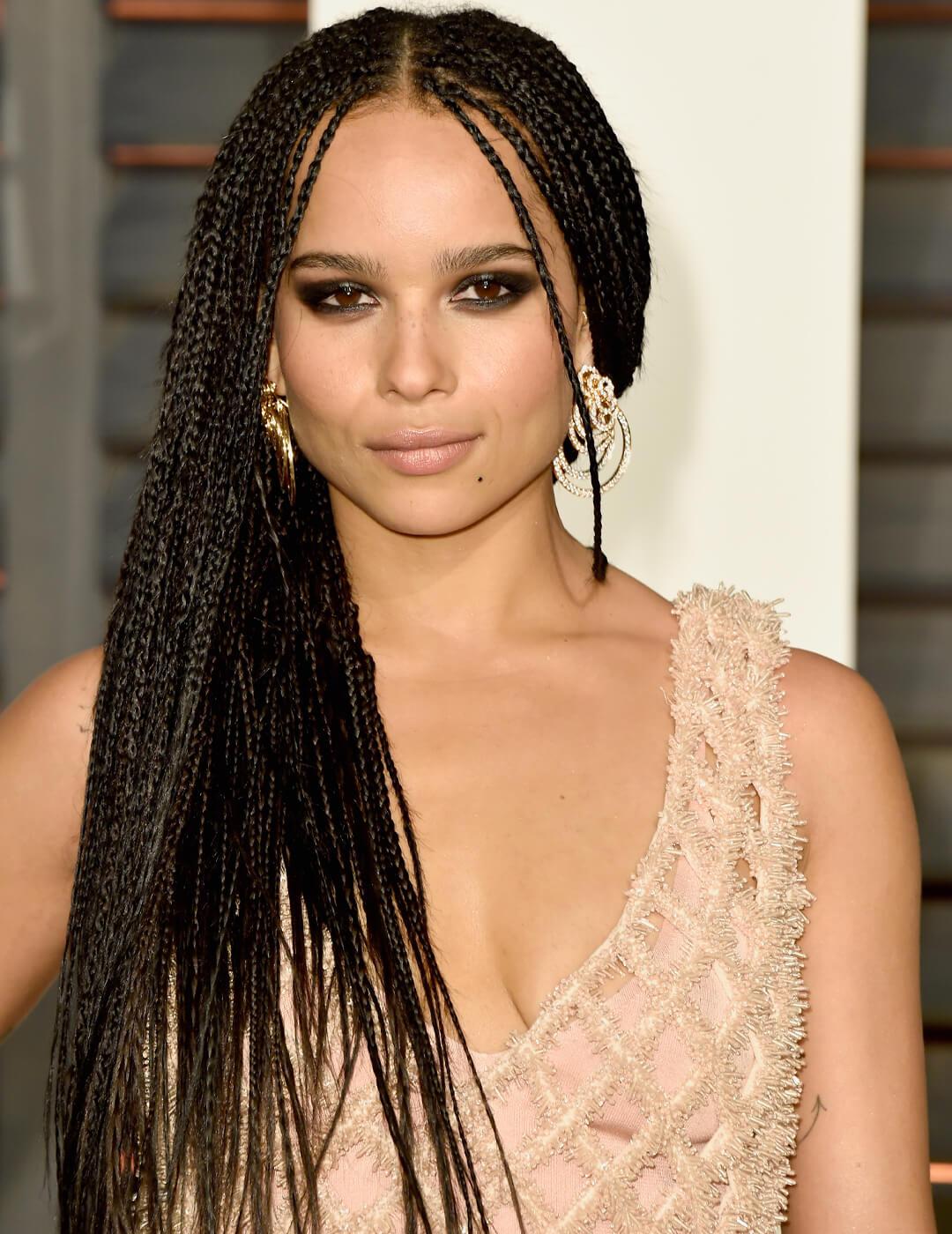Zoe Kravitz in a nude pink, fringed dress rocking her micro braided hairstyle Desktop