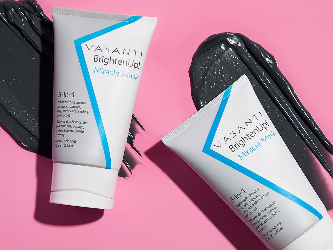 Two tubes of VASANTI COSMETICS Brighten Up! Miracle Mask swatched on pink background Desktop