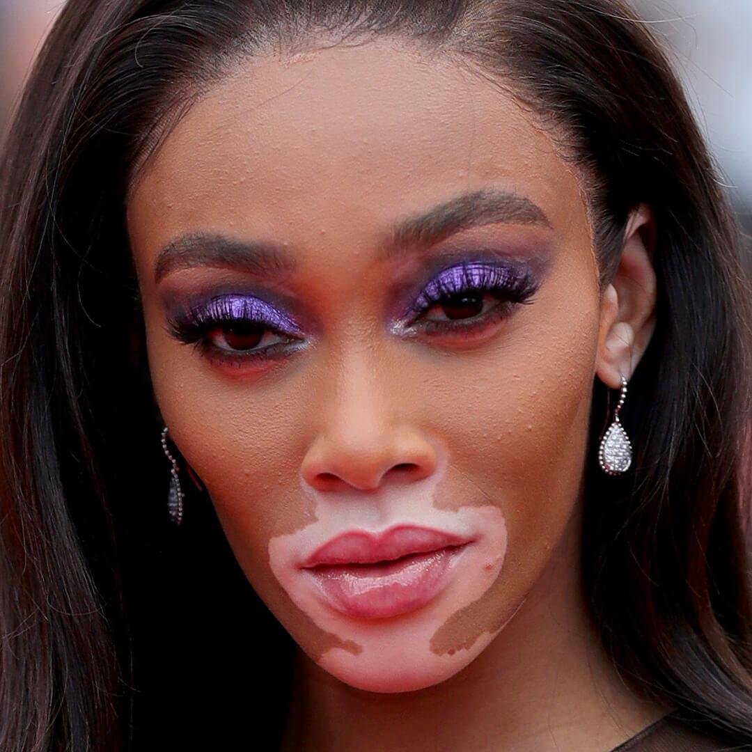 Close-up image of Winnie Harlow rocking a purple smokey eye look Desktop