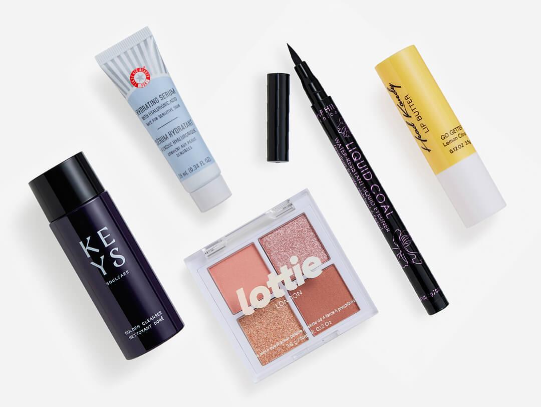 Makeup and skincare beauty products from the July 2023 IPSY Glam Bag on white background Desktop