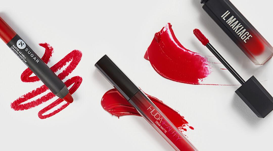 Bright red lip products from various brands swatched Desktop