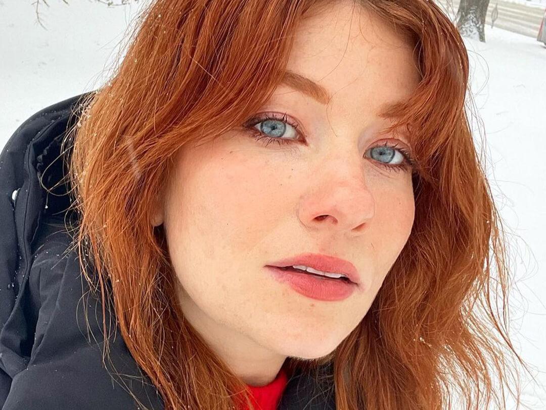 Close-up of a young woman rocking a no-makeup makeup look while out in the snow Desktop
