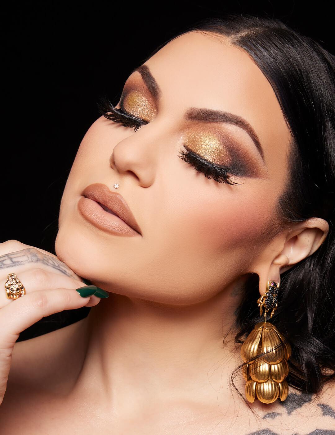 Close-up of Bailey Sarian rocking a golden smoky eye makeup look and nude lips Desktop