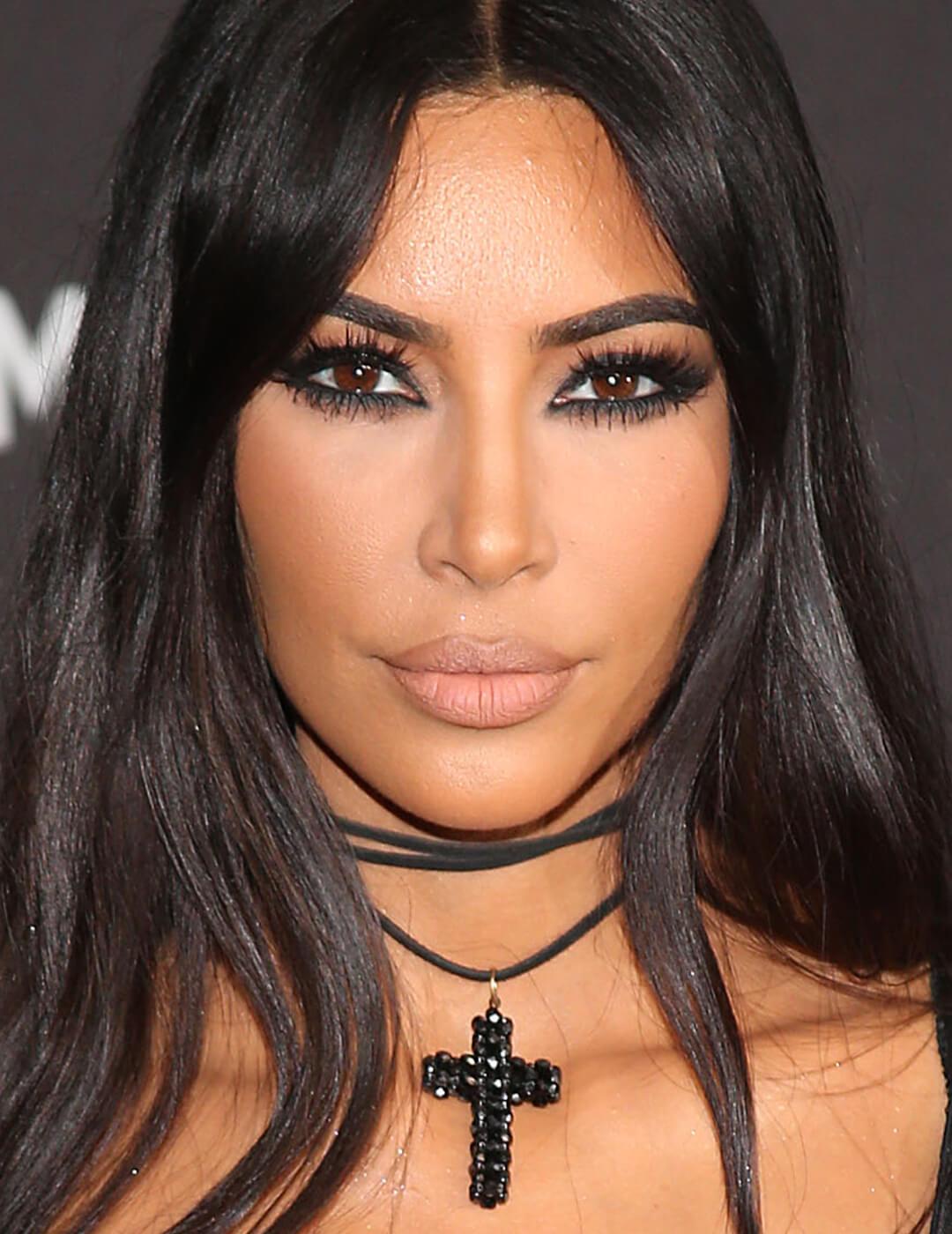 Kim Kardashian looking edgy in a dark eye makeup look Desktop