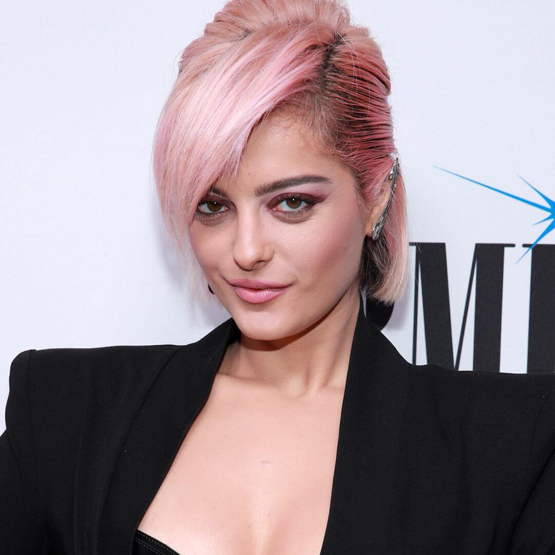 A photo of Bebe Rexha with pastel pink hair and dark pink roots Mobile