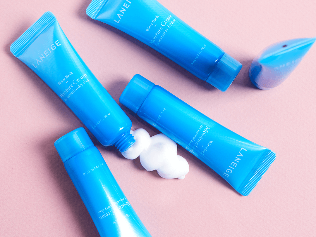 Image of five tubes of LANEIGE Water Bank Moisture Cream swatched on pink background Desktop