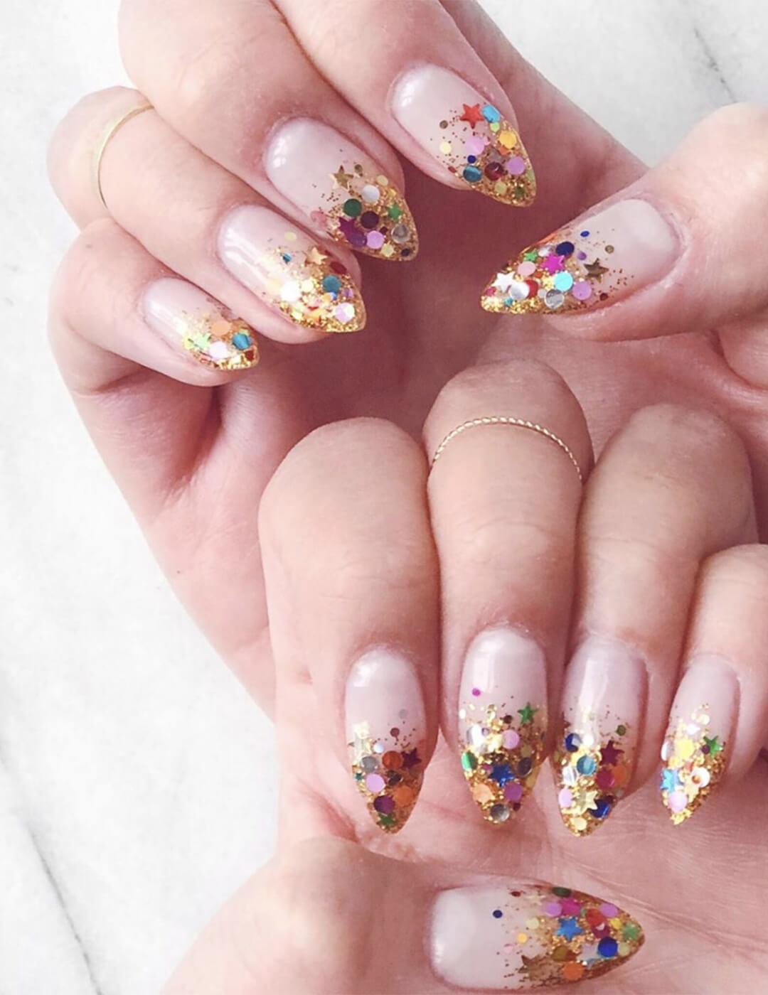 Close-up of a woman's hands with glitter ombré nail art Desktop
