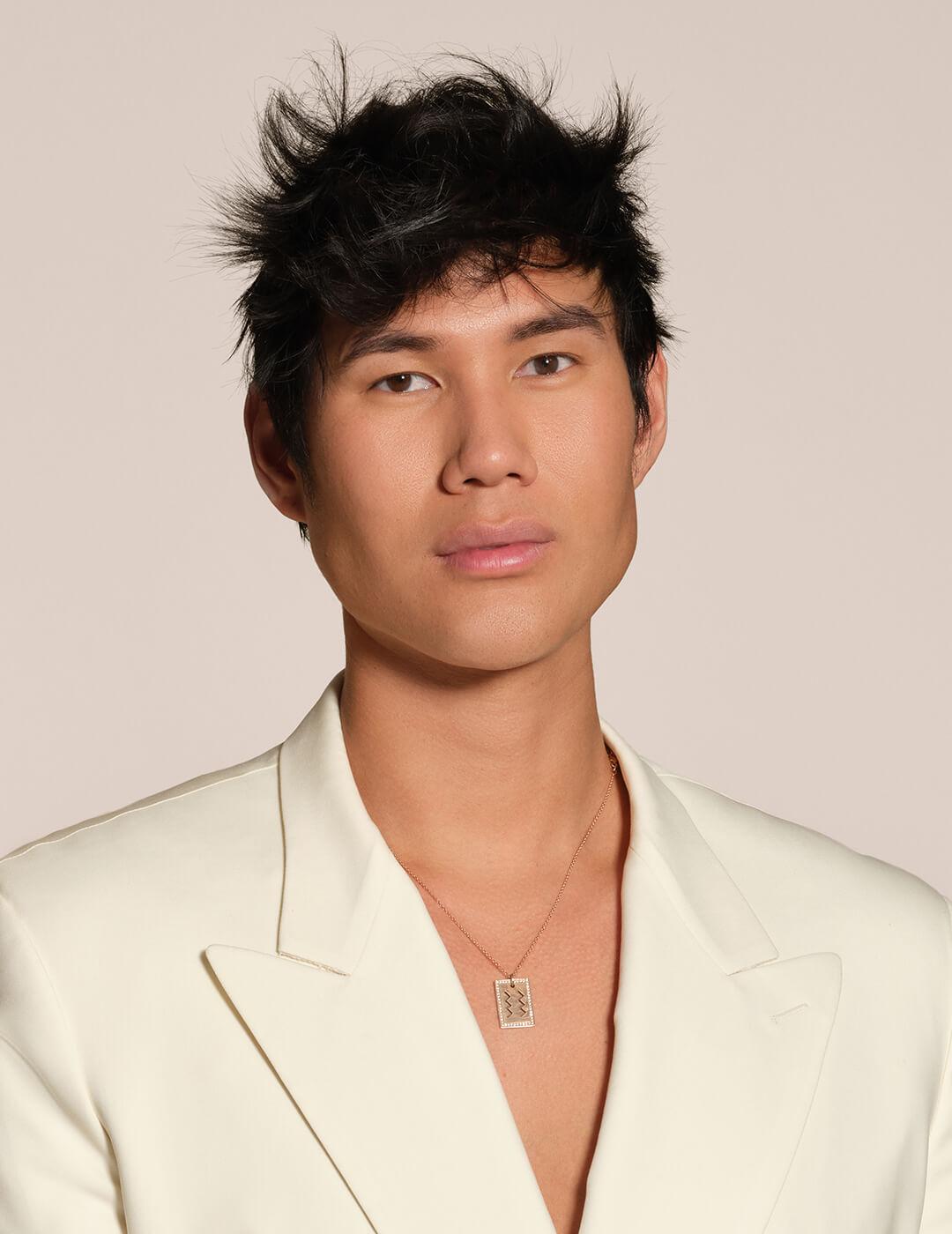 Profile image of Patrick Ta in a cream suit against cream background Desktop