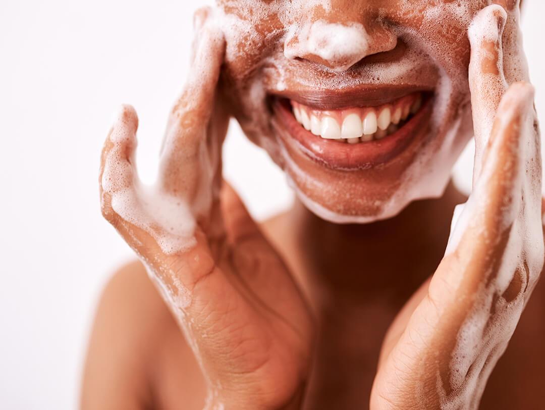 A close up photo of a sliming woman washing her face Desktop