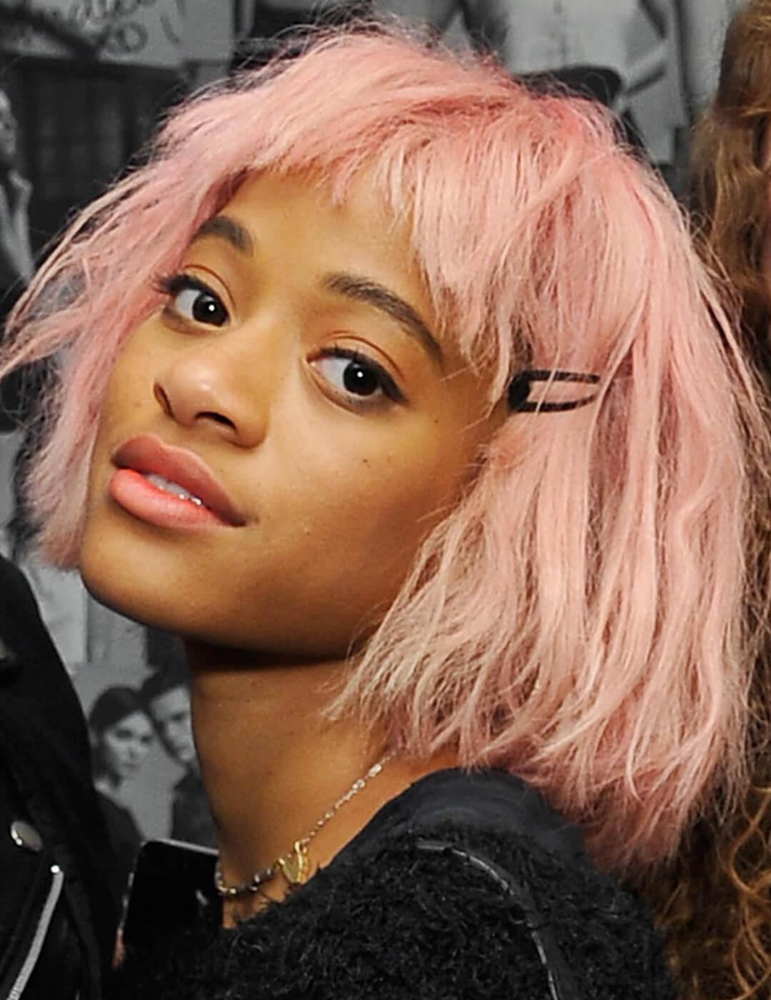 A photo of model Kilo Kish with a pink shag and black hairclip Desktop