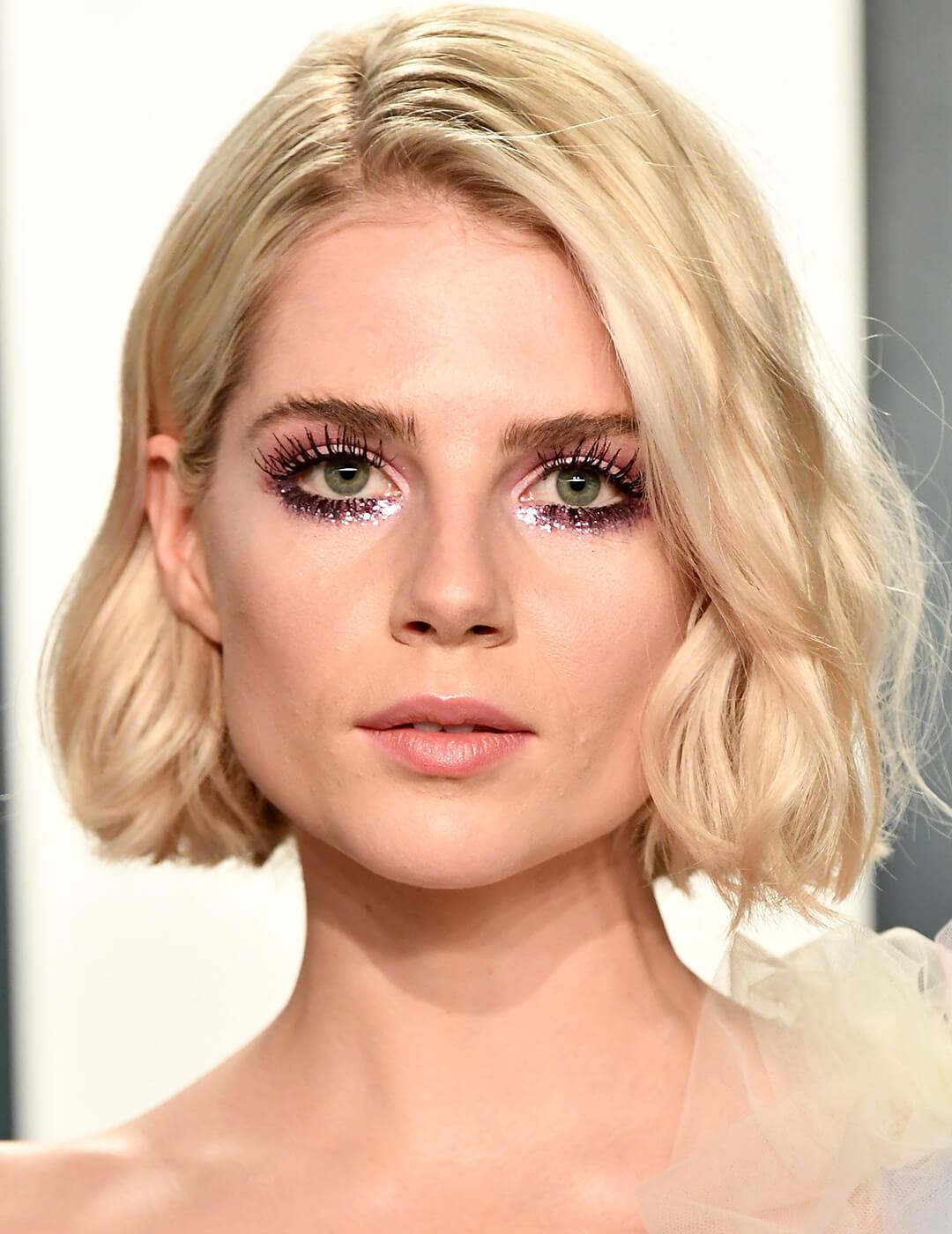 Lucy Boynton looking glam in a glittery pastel eye makeup look Mobile