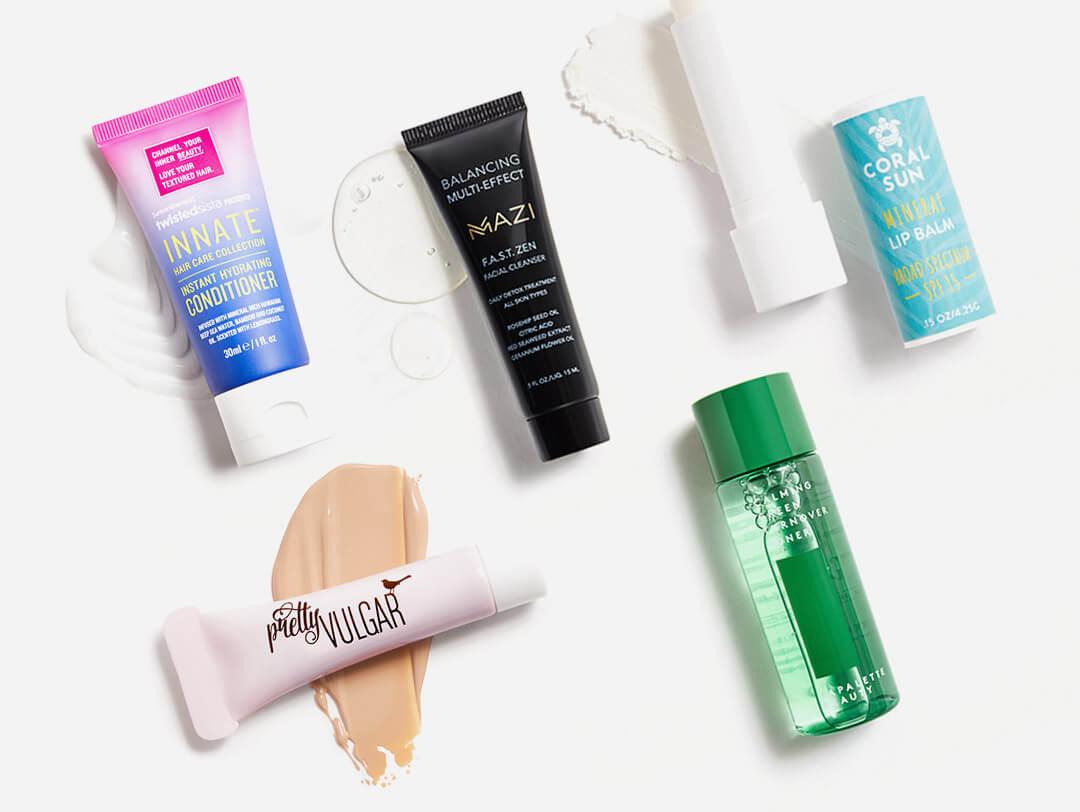 Makeup, skincare, and hair care products from July 2021 IPSY Glam Bag swatched on white background Desktop
