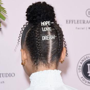 An image of Storm Reid's top bun and braids embellished with statement hair clips Mobile