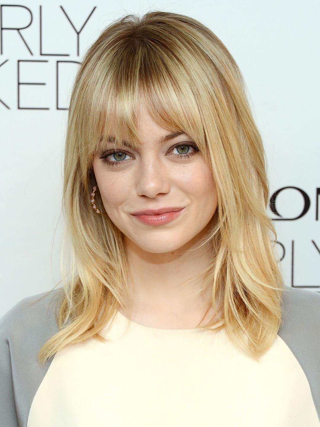 Emma Stone rocking a hairstyle with layered bangs Desktop