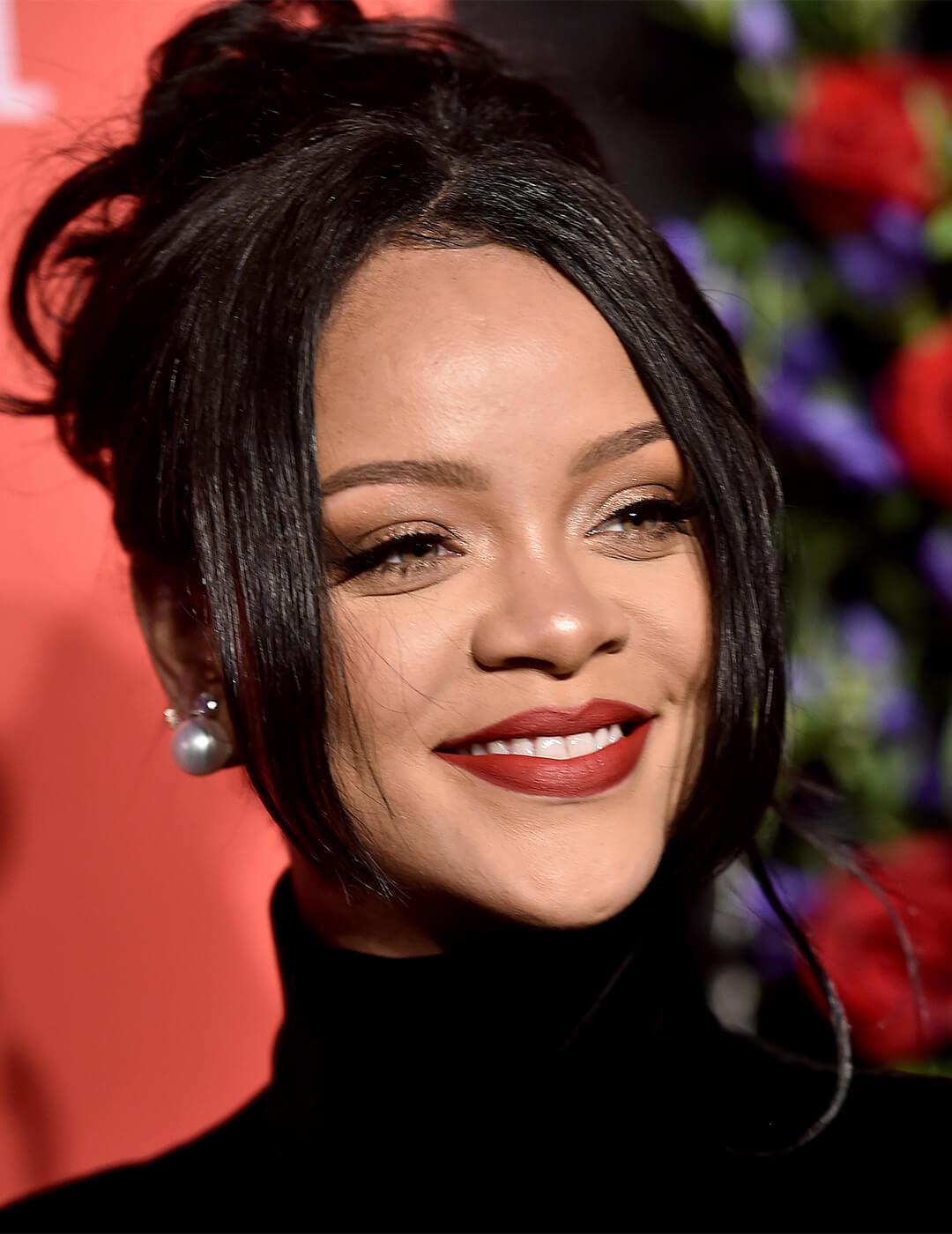 Rihanna rocking a '90s-themed messy bun hairstyle and black turtleneck top at the red carpet Desktop
