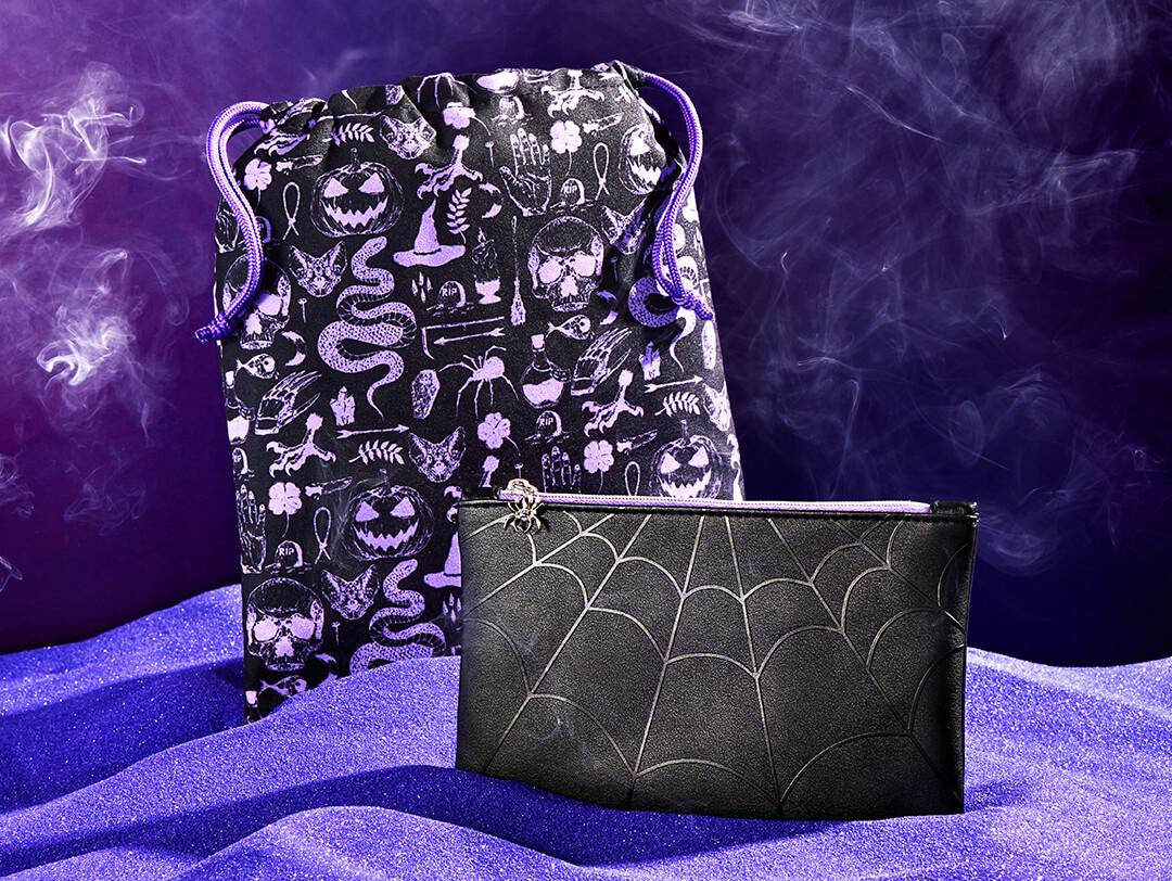 October 2022 IPSY Glam Bag and Glam Bag Plus on dark purple background and purple sad with smoke effect Desktop