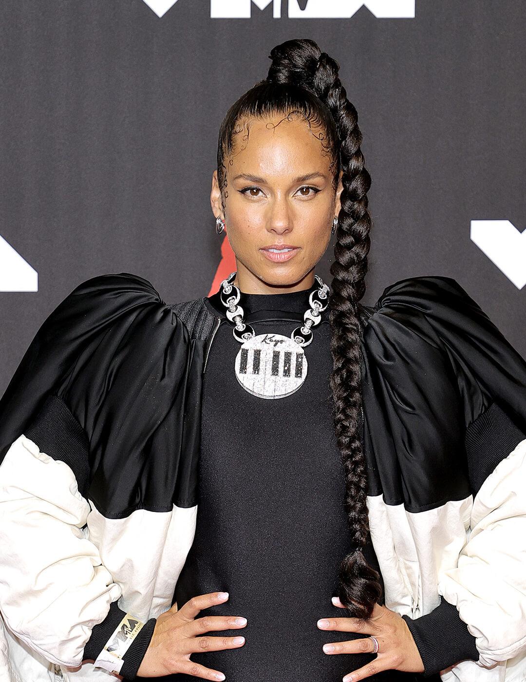 Alicia Keys rocking a braided high ponytail hairstyle and black and white dress on the red carpet Mobile