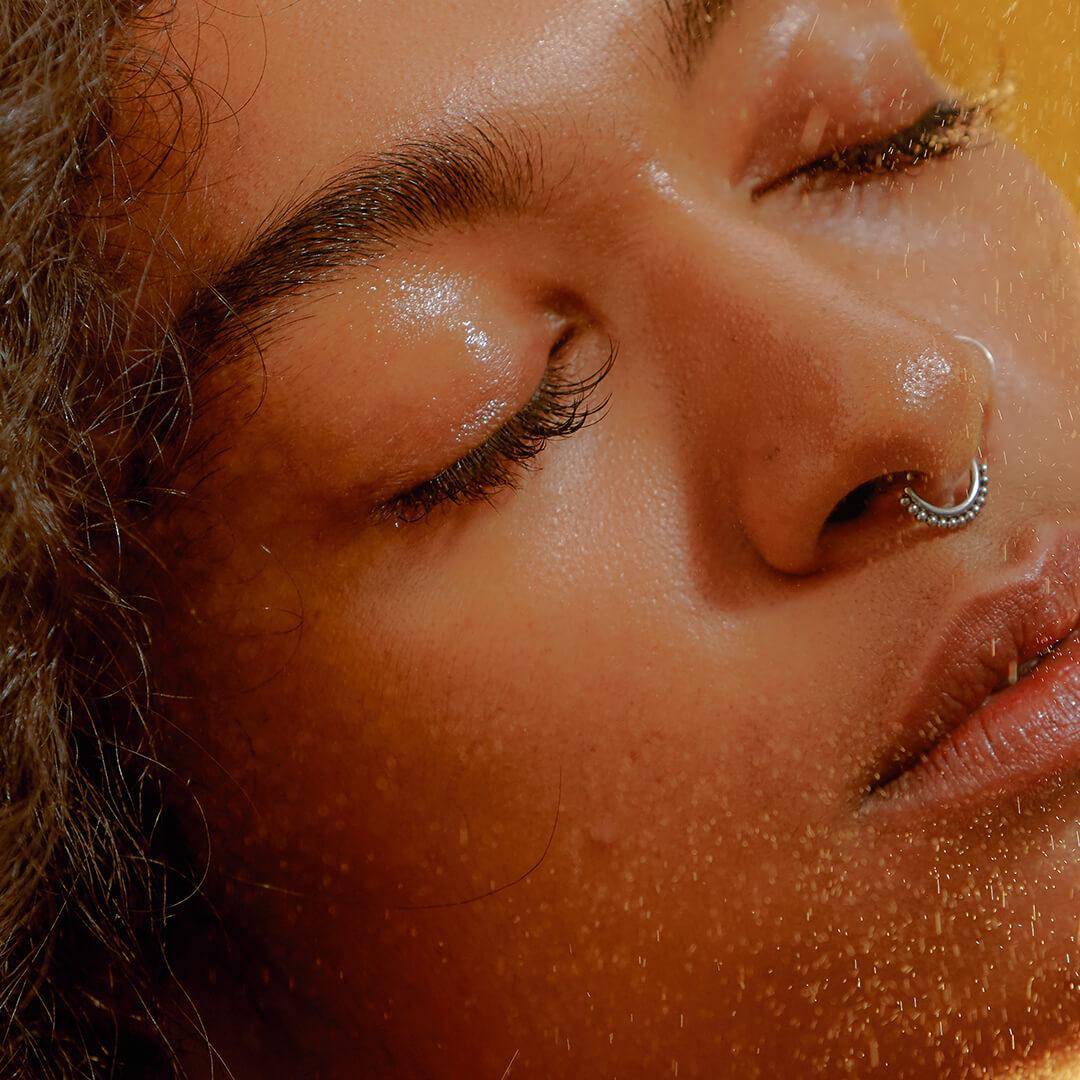 Portrait of Young Confident Woman Using a Facial Spray Desktop