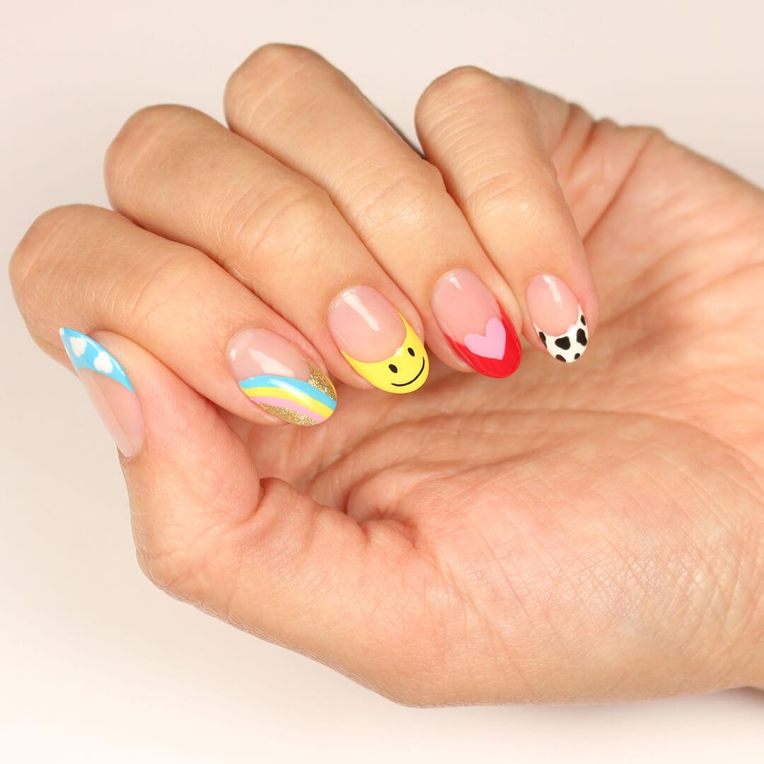 Close-up of model's hand with cute and colorful nail art Desktop