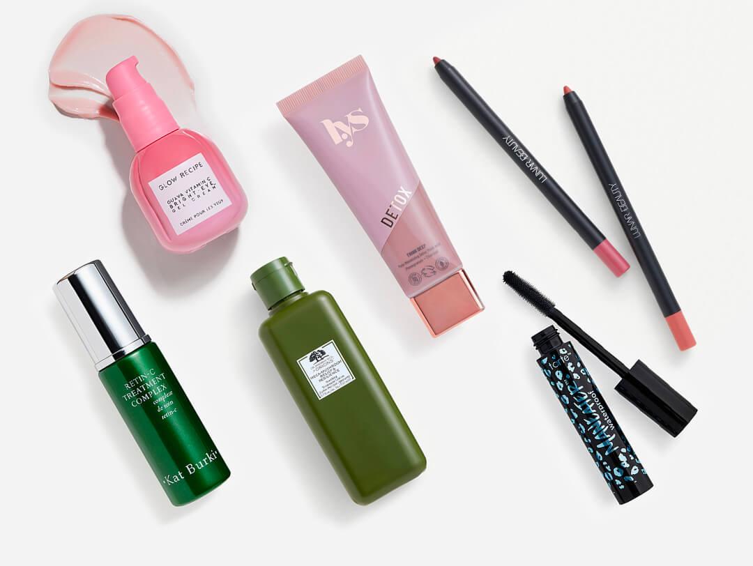 Skincare and makeup products from various brands on white background Desktop