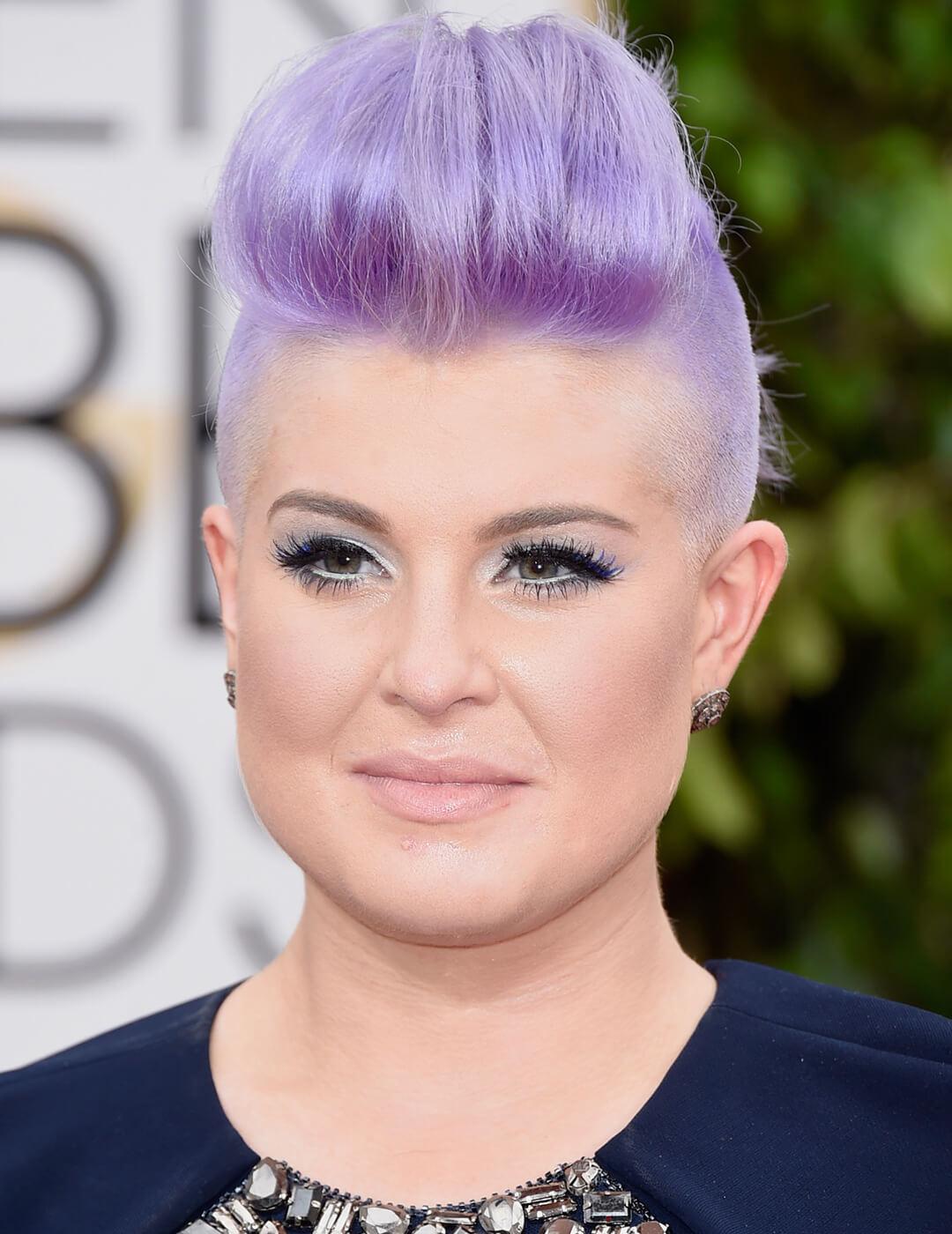 Kelly Osbourne rocking a lavender-colored undercut updo hairstyle, lavender eyeshadow makeup look, and nude lips Desktop