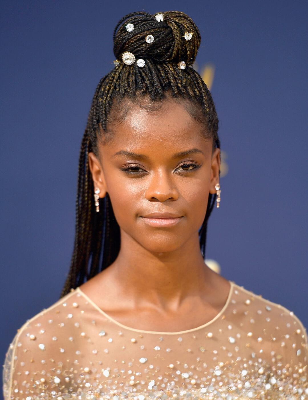 Letitia Wright rocking a braided hairstyle embellished with crystals and sheer nude dress with crystals Mobile