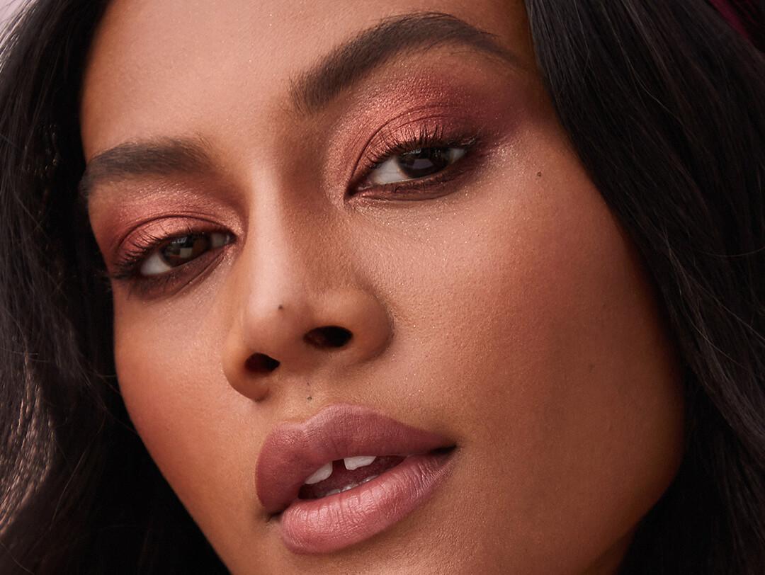 An image of a model wearing red eyeshadow. Desktop