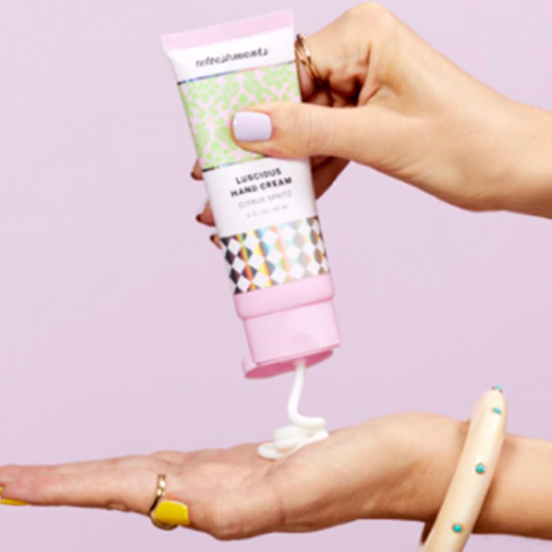 An image of hand-held Refreshments product of IPSY on a pink background Desktop