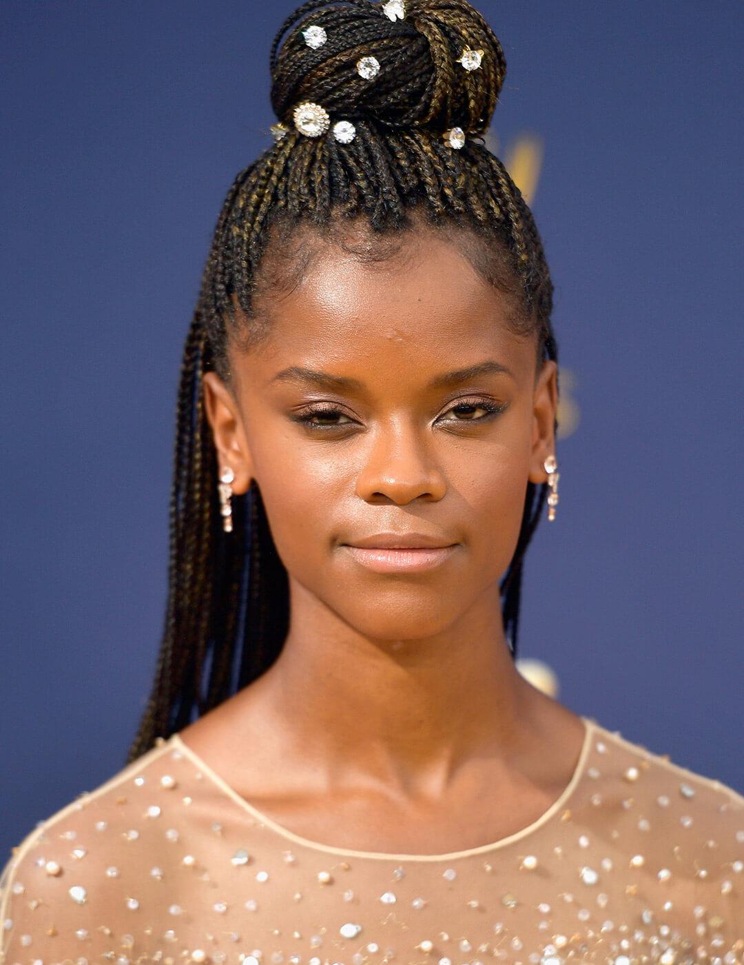 A photo of Letitia Wright with a braided bun and a hair accessories Desktop