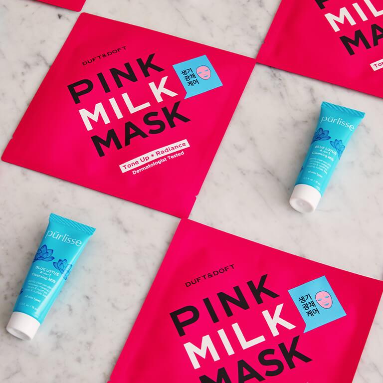 An image of DUFT & DOFT Pink Milk Masks and PURLISSE Blue Lotus 4-in-1 Cleansing Milk neatly arranged Mobile