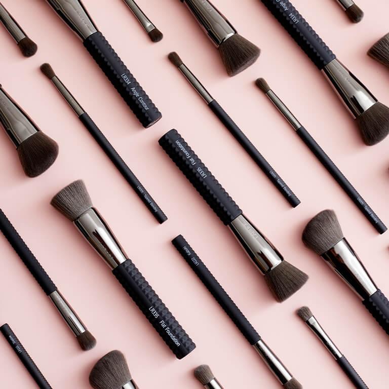 An image of brushes that will be in February's bags and a swatch of pink lipstick. Mobile