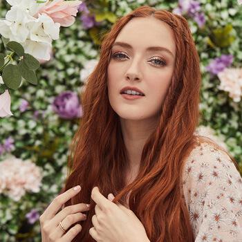 An image of a red-haired model showing her loose twists and braids Mobile