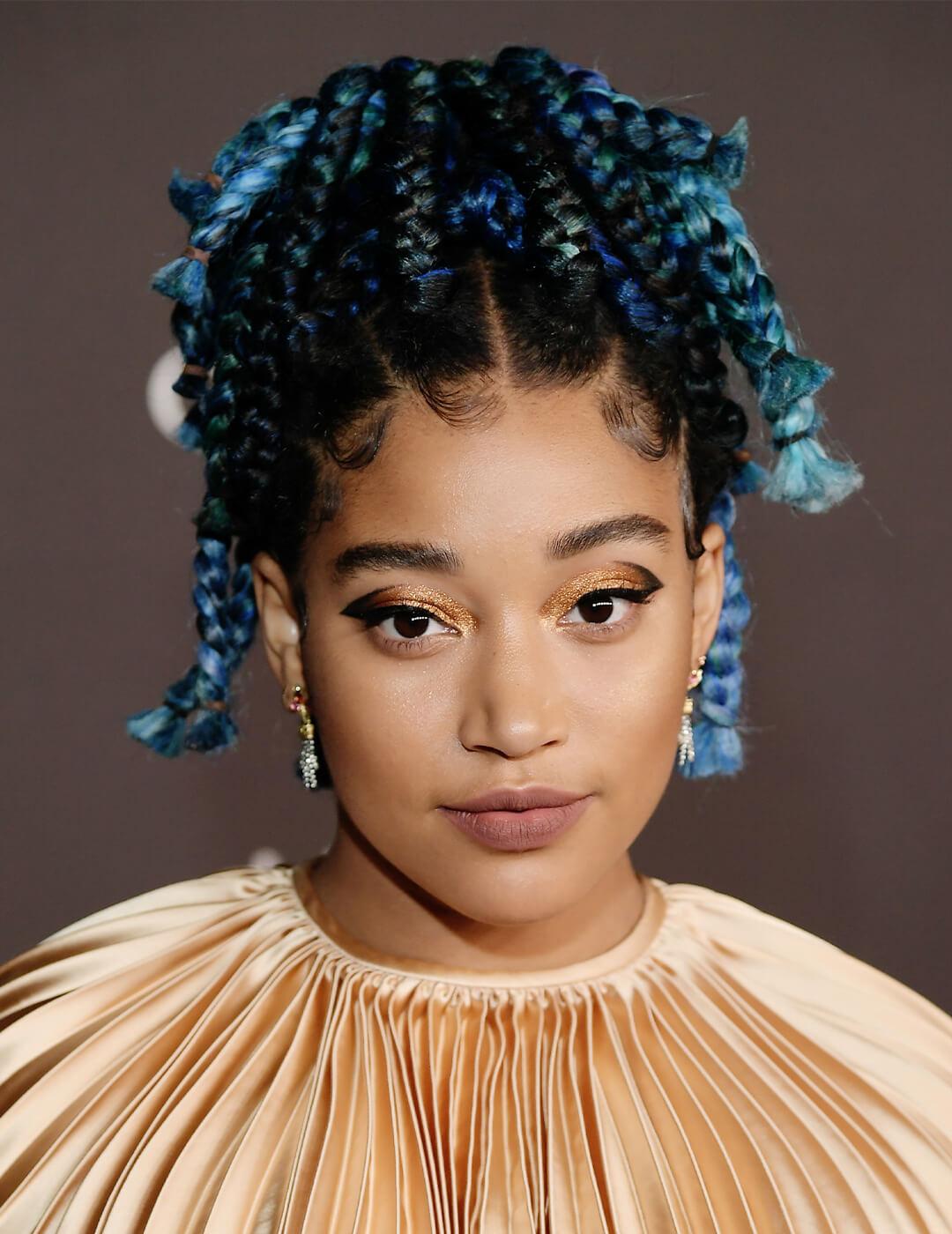 Amandla Stenberg looking glamorous in a textured cream dress and waterfall braided hairstyle Mobile